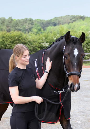 woman on a horse doing the heart sign 