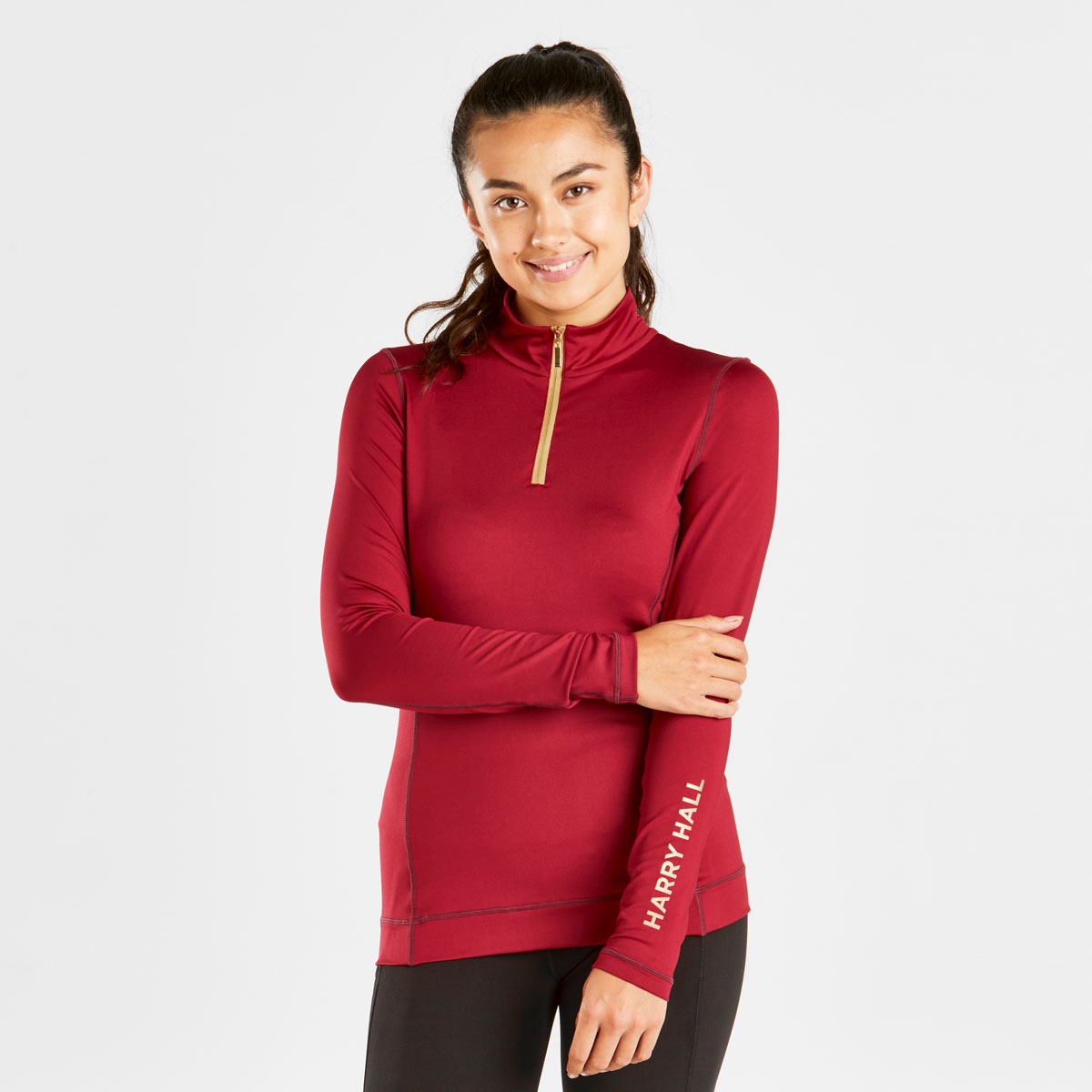 woman wearing a red base layer for horse riding