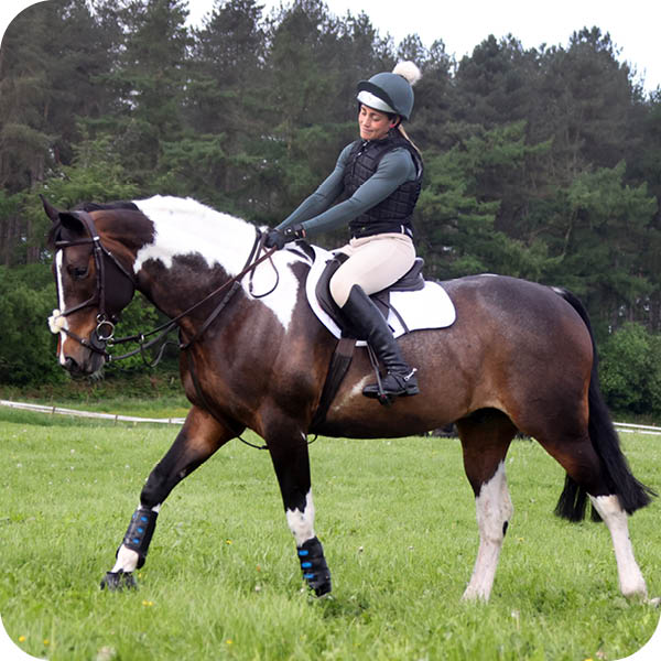 woman on a horse doing the heart sign 