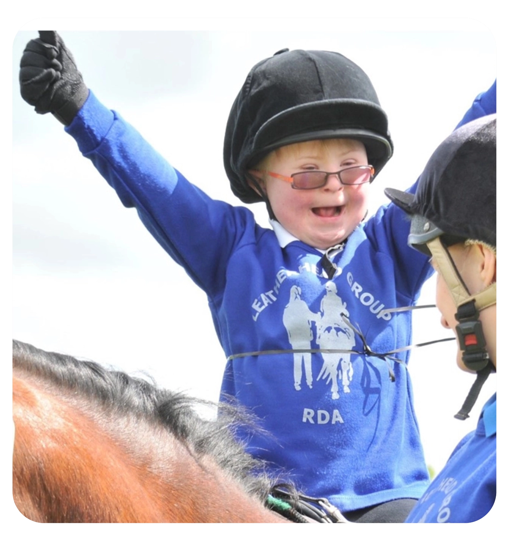 woman on a horse doing the heart sign 