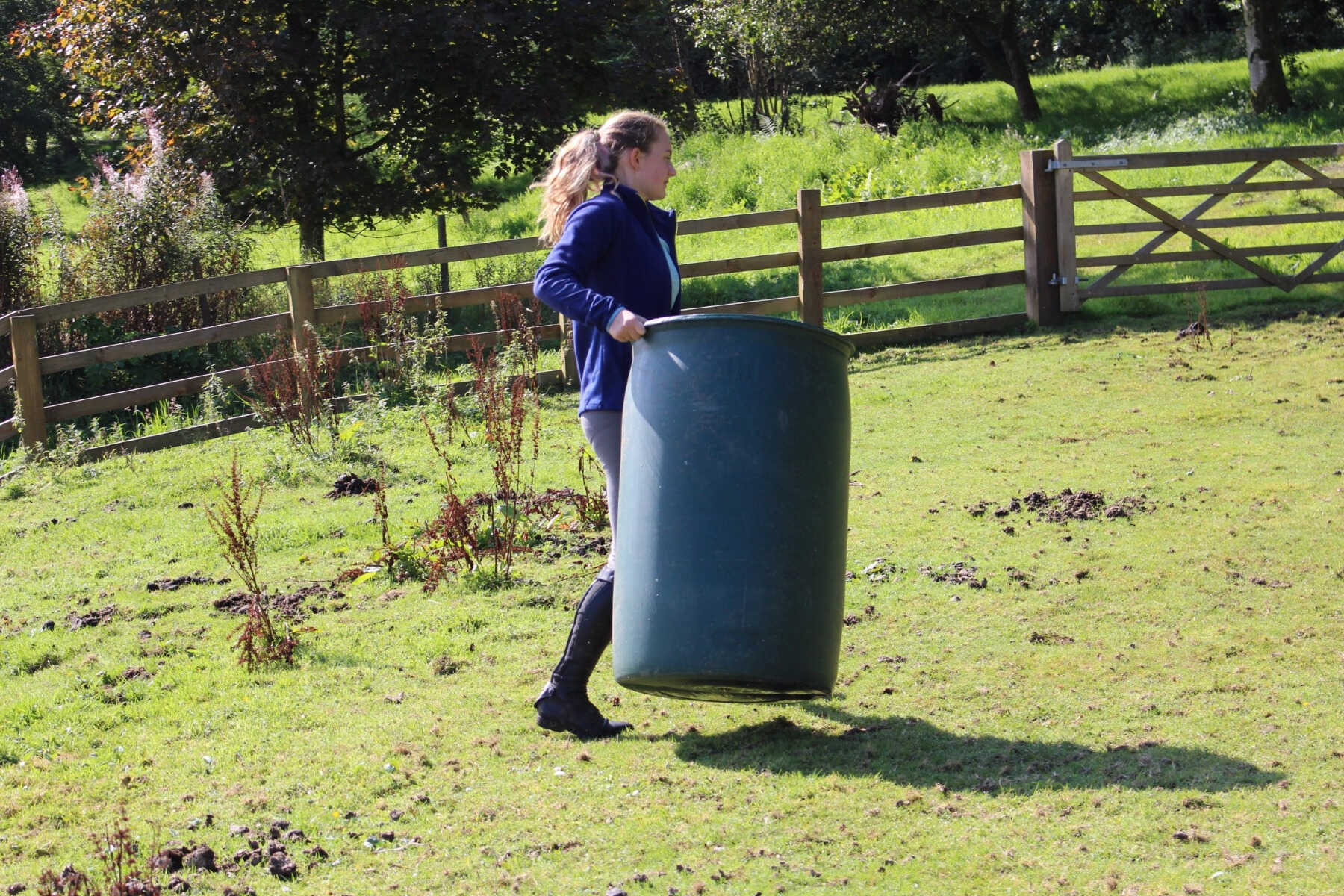 teenage girl carrying a bin 