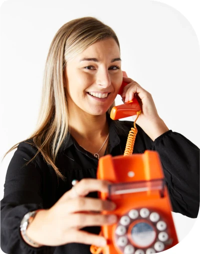 woman holding an orange phone